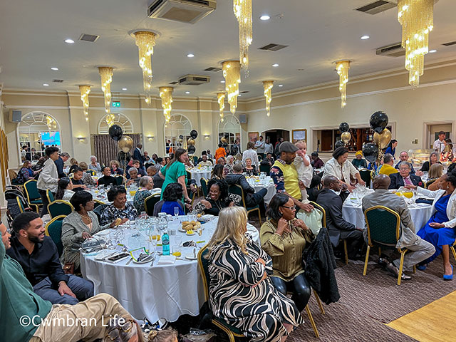 a room full of people sat at tables