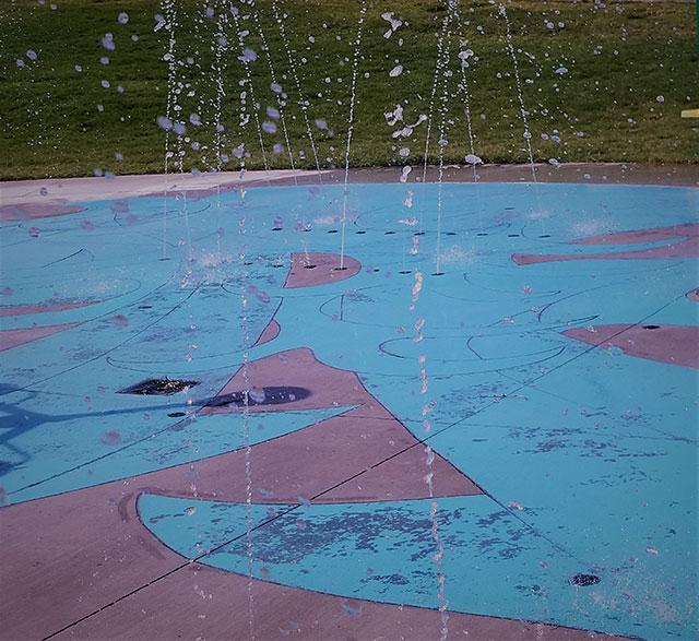 water splashing down on blue and purple tiles