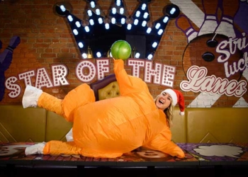 a woman dressed as a turkey in santa hat
