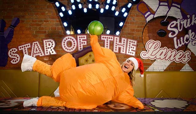 a woman dressed as a turkey in santa hat