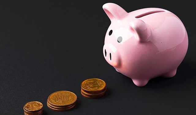 a piggy bank next to coins