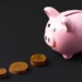 a piggy bank next to coins