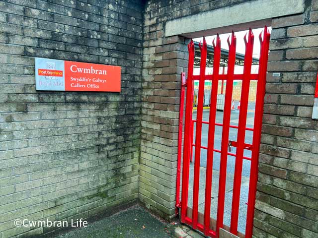 red gates to a royal mail collection office