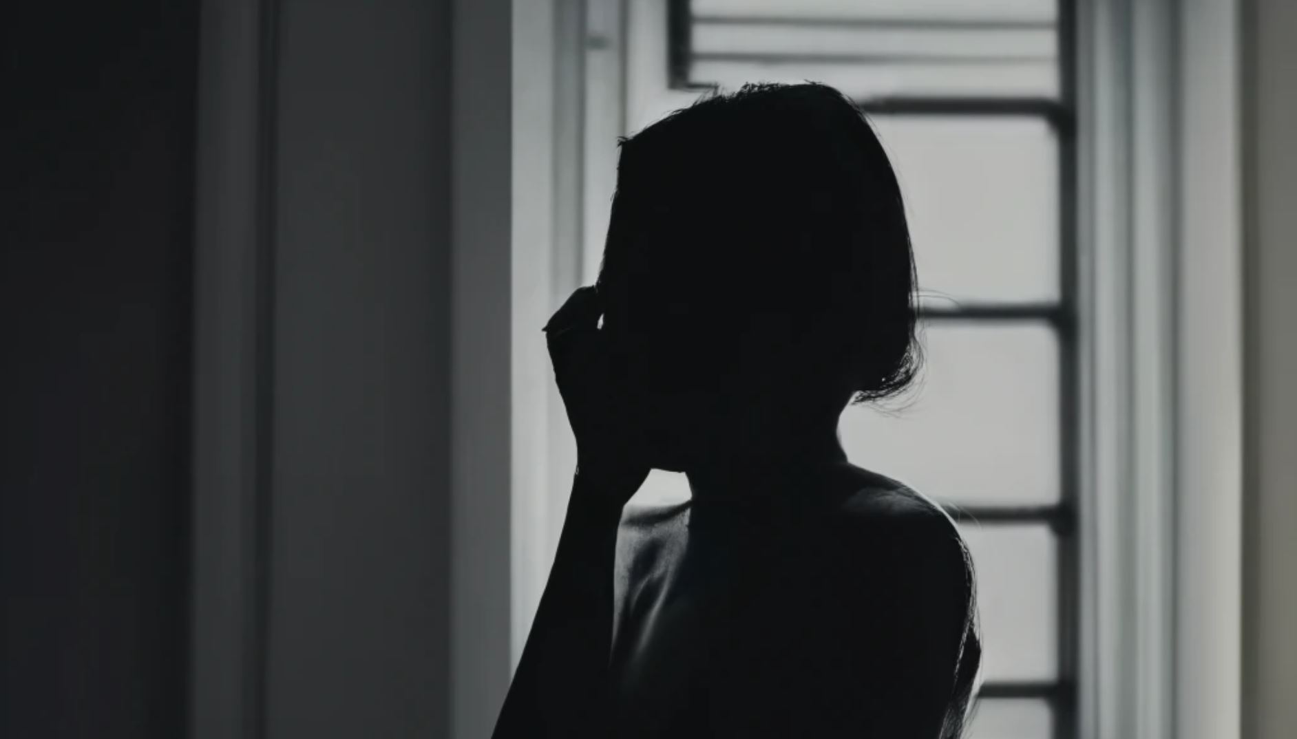 silhouette of a person in front of a window