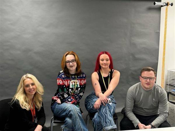 Angharad, Aimee, Eve, and Sam sat on chairs