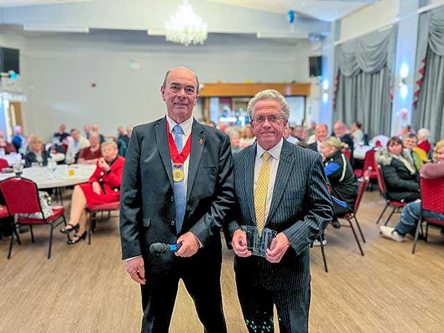 two men in a hall for awards ceremony