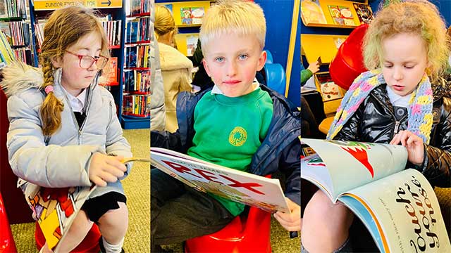 three year 3 pupils reading in a library