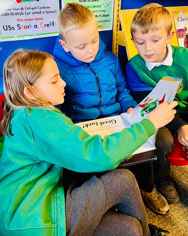 group of pupils read. a book