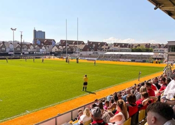 spectators watch a rugby game at Rodney Parade