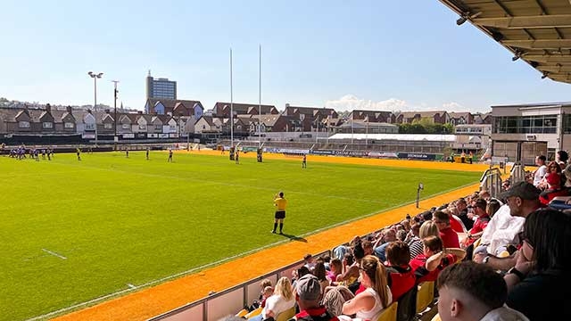 spectators watch a rugby game at Rodney Parade