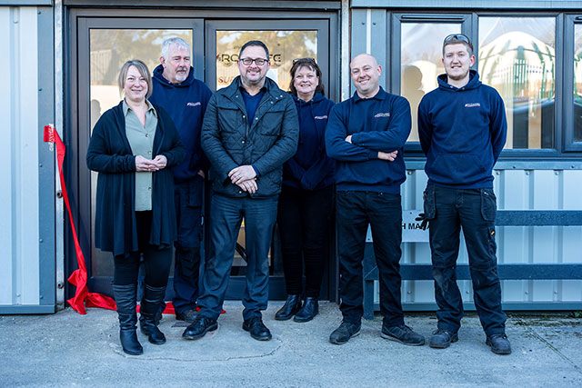 staff outside their factory