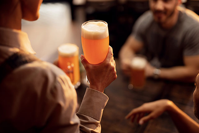 people holding two pints of beer