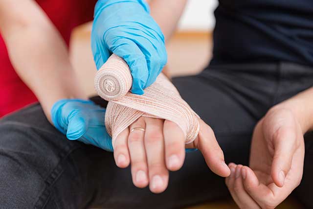 a hand being bandaged