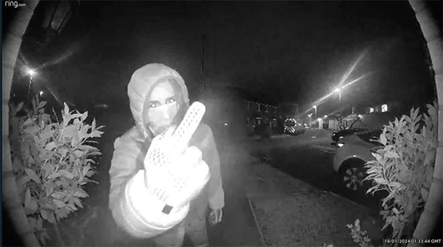 man holds his finger up to ring door bell