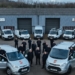 two vans and a team of staff outside a factory unit