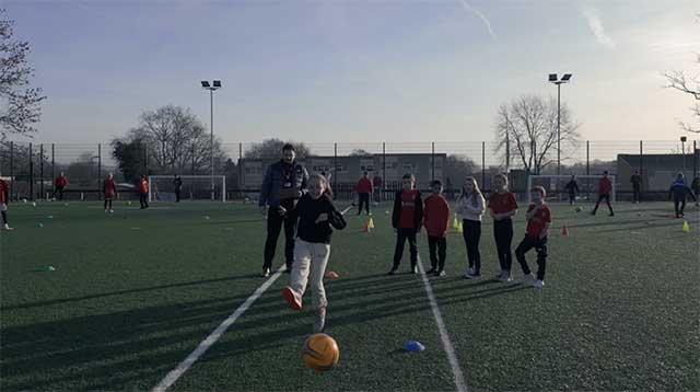a girl shoots at goal