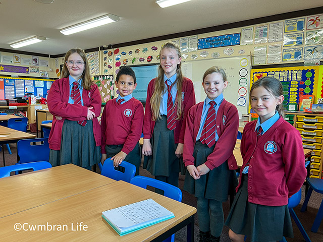 five school children stood in a classroom