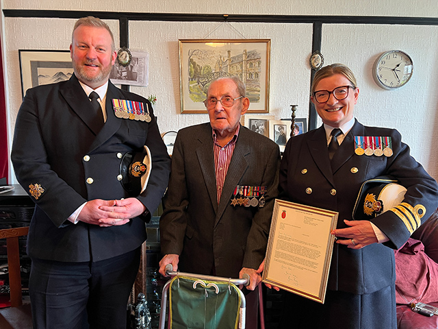 Warrant Officer Rob Govier and Commanding Officer Carolyn Jones, both from HMS Cambria, with Reg Hann