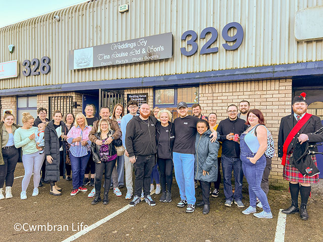 large group of people outside a wedding showroom