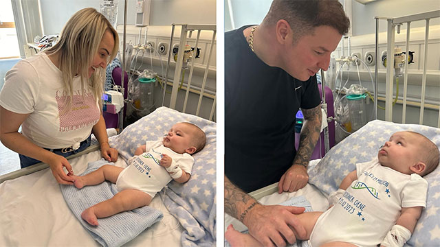 pic of a mum and dad next to their baby lying in hospital bed