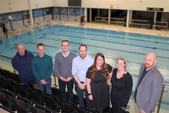 a group of pool stood above a swimming pool