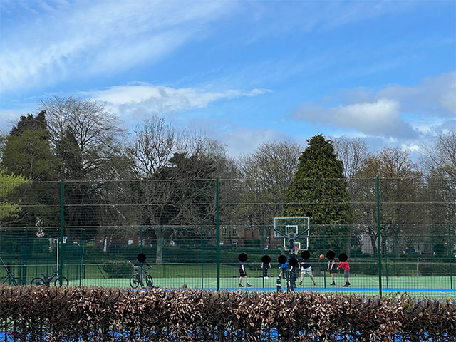 group of teenagers playing basketball