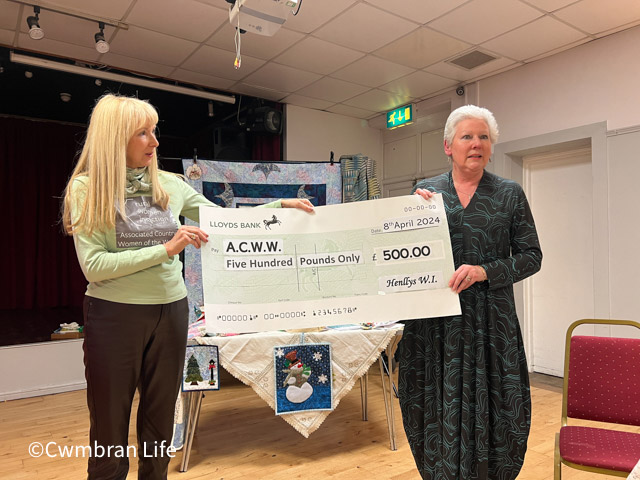 two women holding a cheque