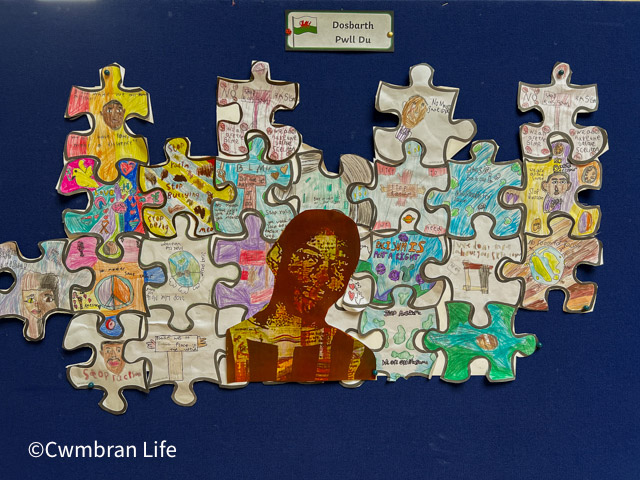 artwork in a jigsaw around a photo of stephen lawrence