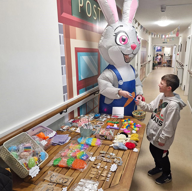 a boy collects a gift from the easter bunny