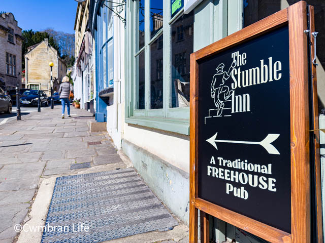 a sign for a pub called 'the stumble inn'
