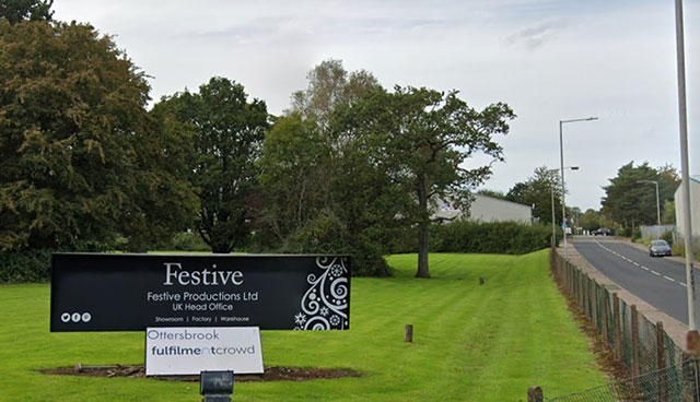 the entrance to factory - sign says festive productions