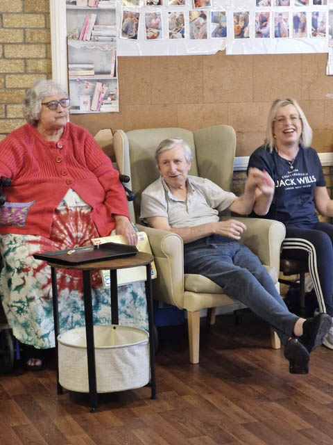 care home residents watch a choir