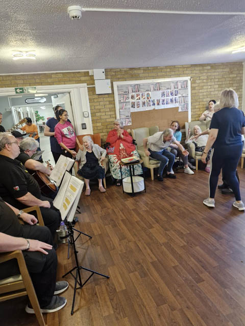 care home residents watch a choir