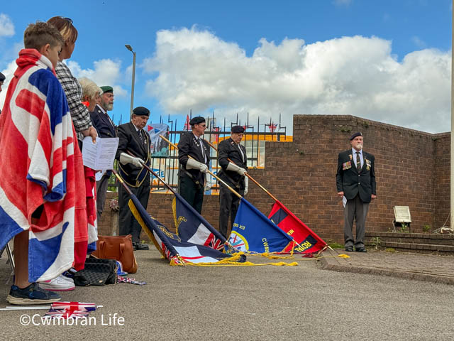 Flags are lowered by veterans at a VE Day service