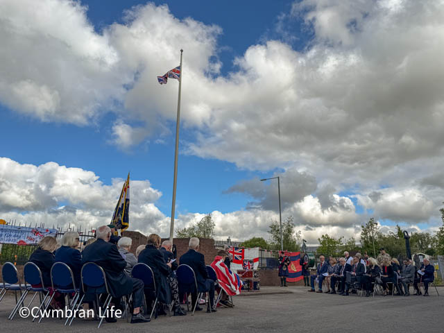 guests sat in chairs at a service to remember VE Day