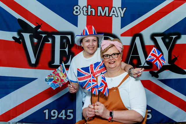 two women in front of a large union jack