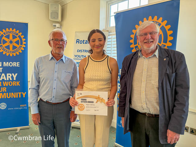 two men and a teenage girl holding a certificate