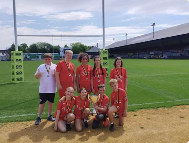 The Ysgol Gymraeg Cwmbrân tag rugby team on a rugby pitch