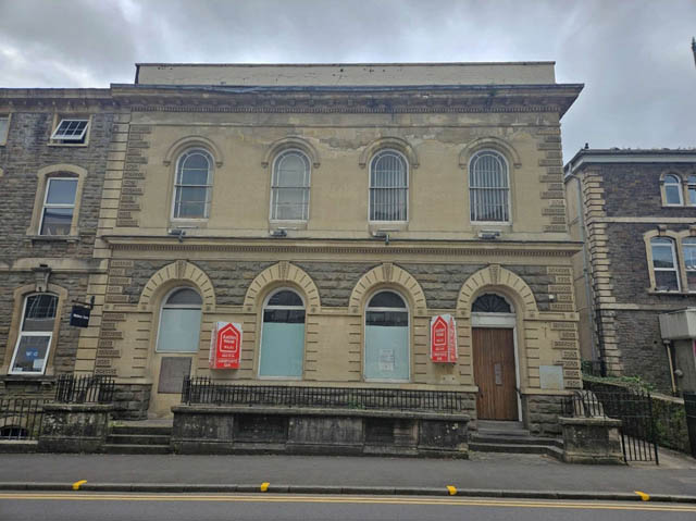 a former bank in a high street boarded up