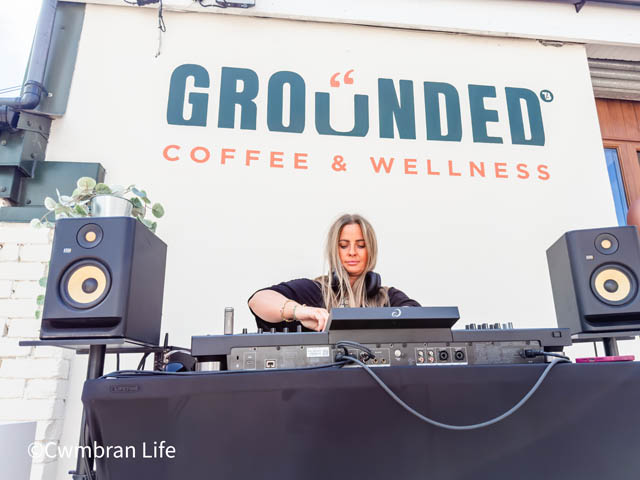 a DJ plays records at a set of decks