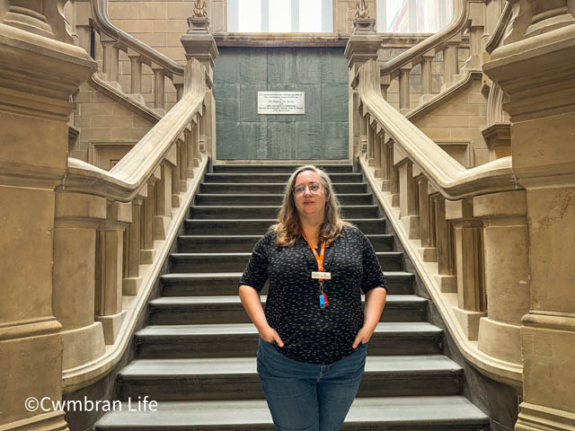 a woman stood at the bottom of a large stone staircase