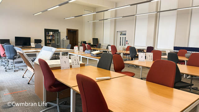 a room with several tables and chairs