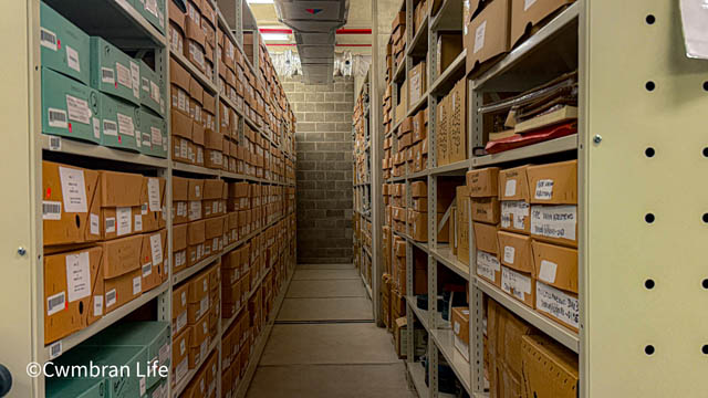 an aisle of documents in an archive room