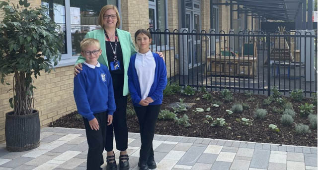 Emma Payne, headteacher, with pupils Alfie and Ellie outside the new school