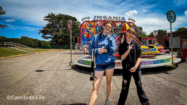 two girls by a fairground ride
