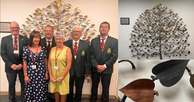 Members of Greenmeadow Golf Club and staff from Ty Hafan stood by the 'silver leaf'