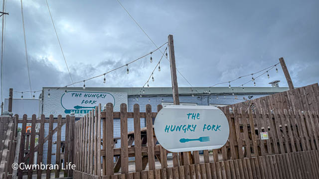 the outside area of a cafe called the hungry fork