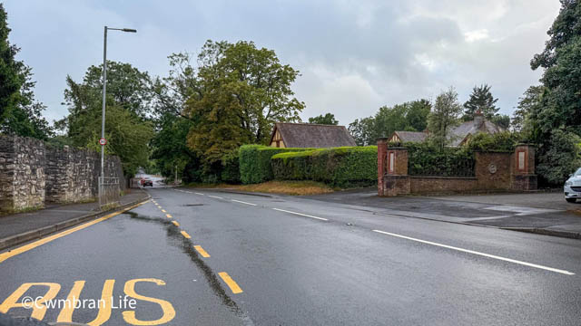 a road with a bus stop on the left