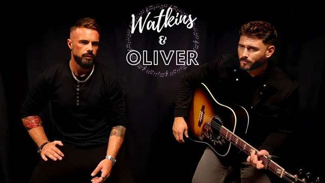 Watkins & Oliver sat on chairs performing