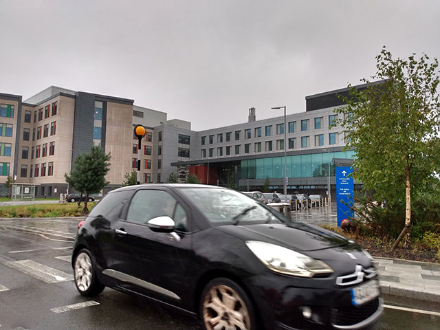 a car driving past a hospital